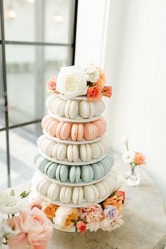 a stack of seashells and flowers on a table