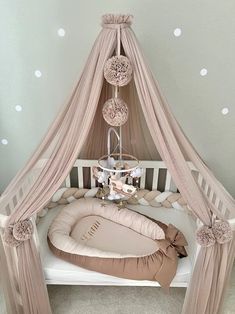 a baby crib with a canopy over it