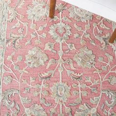 a pink rug with floral designs on it