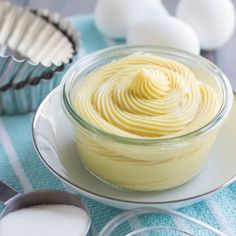 an image of a bowl of food on a table with eggs and utensils