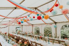 the inside of a tent with tables and chairs set up for a wedding or party