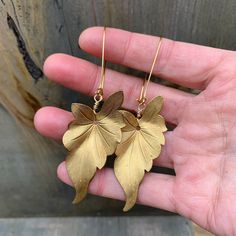 These brass philodendron -leaf drop earrings are golden & bold! They can accompany a classy look or add some shine to an earthy combo. They are paired with 18k gold-plated & nickel free kidney ear-wires. They fall at approximately 3.75" long and are 1.25" at the widest part of the leaf. These earrings are both Beautiful & botanical & shimmer with natural beauty ✨ Yellow Gold Leaf-shaped Brass Earrings, Nickel-free Leaf-shaped Brass Jewelry, Gold Leaf-shaped Single Earring, Gold Single Leaf-shaped Earring, Gold Leaf-shaped Nickel-free Earrings, Gold Leaf Nature-inspired Jewelry, Leaf-shaped Yellow Gold Brass Jewelry, Gold Leaf-shaped Earrings, Gold Leaf-shaped Hoop Earrings For Gift