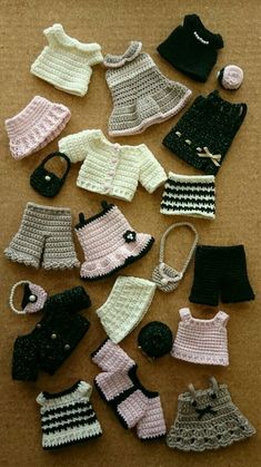 crocheted clothes and accessories are laid out on the floor