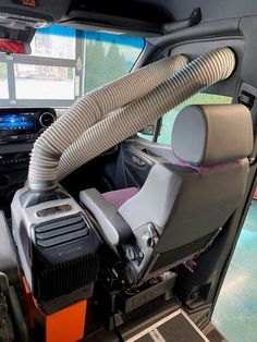 the inside of a vehicle with an air vent and various electronics in it's compartment