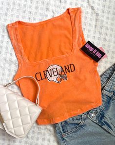 Cleveland Browns tank; Acid wash, bright orange crop top;  I'd say this top runs slightly small to true to size  *the model in the final photo is wearing a size small*  Small: Length - 16.5" , Bust 27" Medium: - 17" , bust 29" Large: - length 17.5" , bust 31" if you have any questions about sizing, restock, or shipping times, feel free to send me a message! Orange Sports Tops For Summer, Trendy Orange Sports Top, Sporty Orange Summer Top, Casual Orange Tank Top For Sports, Orange Casual Tank Top For Sports, Vintage Brown Top With Text Print, Trendy Orange Cotton Crop Top, Cleveland Browns Outfit Woman, Browns Game Outfit Cleveland