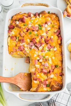 a casserole dish with ham and cheese in it on a white counter top