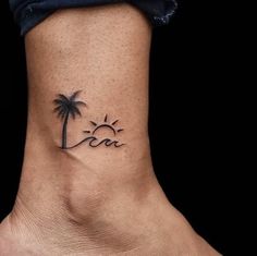 a small palm tree tattoo on the ankle