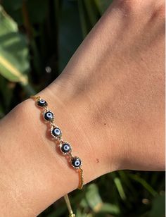 Our 18K gold filled Evil Eye Bracelet is handmade by a Mexican artisan, tarnish-free, water-safe, hypoallergenic, and a perfect way to keep all the bad vibes away and stay looking cute. Our black evil eye brings power and prosperity, and who doesn't need that? This bracelet is adjustable so it fits any wrist, making it a perfect gift! Remember, any evil eye is much more powerful when it was received by someone else, so grab one and gift it to a loved one that needs that extra protection in their Resizable Yellow Gold Bracelet, Adjustable Gold Charm Bracelet With Evil Eye, Adjustable Gold Plated Evil Eye Jewelry, Gold Resizable Evil Eye Spiritual Bracelet, Gold Resizable Spiritual Evil Eye Bracelet, Spiritual Silver Gold-plated Bracelets, Silver Gold-plated Spiritual Bracelets, Adjustable Gold Plated Tennis Bracelet, Resizable Gold Spiritual Evil Eye Bracelet