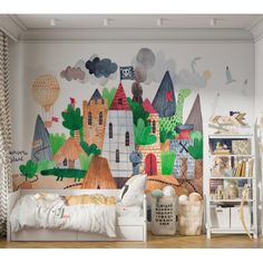 a child's bedroom with a mural on the wall