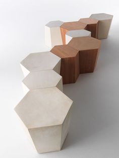 an assortment of different shapes and sizes of stools on a white surface with shadows