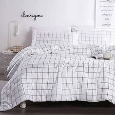 the comforter is white and black with a checkered pattern on it's bed