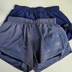 Two Xs Running Shorts With Built In Bike Shorts By New Balance. Sold As A Pair - The Gray One Is Brand New With Tags. The Navy Pair Was Tried On But Not Worn (Tags Cut Off). Gray Running Bottoms With Pockets, Blue Athletic Shorts With Pockets For Running, New Balance Sporty Bottoms For Sports, Blue Running Shorts, Blue Training Shorts With Pockets, Blue Athletic Running Shorts With Built-in Shorts, New Balance Shorts, Blue Squat-proof Sports Shorts, Moisture-wicking Blue Activewear Shorts