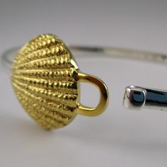 "This sterling silver Scallop Shell Bangle features a silver band with a ridged, gold vermeil scallop shell. The bangle accommodates large spacer beads and traditional charms. Marked Brown County Silver and Sterling inside the band. Also marked S.W.P. for designer Steven Wesley Patterson. Brand new, never worn condition. Available in medium only. Medium - 7.25\" Approximate weight is 14 grams *Sand dollar charm sold separately." Mark Brown, Vacation Jewelry, Brown County, Beach Bracelet, Beach Bracelets, Scallop Shell, Jewelry Charms, Scallop Shells, Shell Bracelet