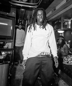 a man with dreadlocks standing in a room