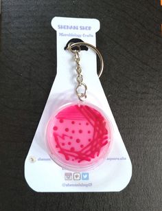 a keychain with a pink and red design on it's front end