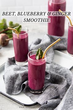 beet, blueberry and ginger smoothie in glasses with strawberries on the side