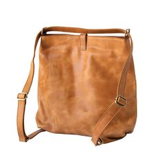 Our full-grain leather slingback is perfect for the girl looking for functionality! It serves as a crossbody and backpack! Just pull on the straps for an over the shoulder look, or wear it like a crossbody to mix this bag into your on-the-go lifestyle. This bag is fully-lined and comes with a detachable fringe accessory. There are two button closures that help reinforce your belongings at the top as well! This bag is going to be your next closet staple. Features: 12" wide, 14.5" tall, 4" deep 2- Chic Leather Backpack With Leather Handles, Brown On-the-go Bag With Adjustable Straps, Chic Leather Backpack Shoulder Bag, Casual Leather-lined Crossbody Hobo Bag, Brown Leather Backpack With Adjustable Strap For On-the-go, Versatile Leather Backpack, Chic Leather Shoulder Bag Backpack, Casual Hobo Bag For Travel With Leather Lining, Casual Hobo Bag With Leather Lining For Travel