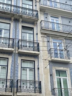 an apartment building with balconies and wrought iron railings