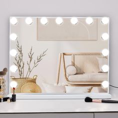 a vanity mirror with lights on it next to a chair and other makeup items in front of the mirror