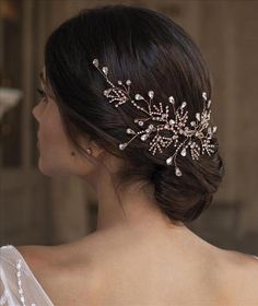 a woman wearing a bridal hair comb with crystal stones and pearls on the side