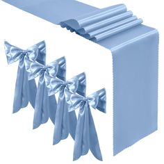 a blue table runner with silver bows on it