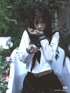 a woman sitting in a bathtub holding food