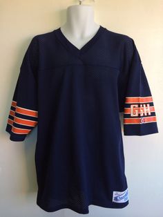 Here's an 80's Bears jersey for any fan. It's an authentic, never before worn, pristine condition rarity! It has the classic GSH painted on the sleeve to commemorate Papa Bear and is otherwise blank, supporting the whole team, the fans, Chicago, and everything Bears! Condition: Mint. Check out other vintage jerseys & sports gear in my shop https://www.etsy.com/shop/sweetVTGtshirt?section_id=11916422&ref=shopsection_leftnav_5 Label: Champion Color: Navy Material: 100% Nylon Measurements ( Chicago Bears Jersey, Jersey Vintage, Papa Bear, Vintage Jerseys, Vintage Football, Retro Shirts, Sports Gear, Chicago Bears, Football Jersey