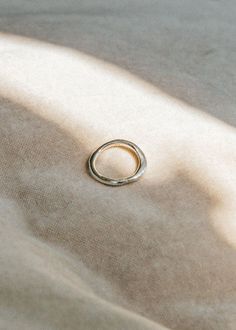 The Contour Ring is hand carved and casted in solid sterling silver. Like tracing the contours of an object with your eyes closed, the Contour Ring is based on the concept of a blind contour. A form follows, creating something that is imperfect yet feels complete. Details * Measures about 3-4mm at widest part of the ring. * Made from recycled Sterling Silver for everyday, so you don't have to be precious with it. * Sterling silver doesn't contain metal additions that can typically cause infections or allergic reactions. * The oils on your skin keeps sterling silver clean, wear often to prevent tarnishing over time. * Wear and scratches will show with time like all precious metals, but we think character is beautiful. * Handmade in Toronto, Canada to order. Allow 2-4 weeks to ship. Free shi Minimalist Hallmarked Dome Ring For Everyday, Silver Brass Rings Fine Jewelry, Minimalist Hammered Engraved Promise Ring, Minimalist Engraved Brass Rings, Minimalist Hand Forged Sterling Silver Engraved Ring, Minimalist Hallmarked Dome Ring, Silver Brass Stackable Rings For Promise, Minimalist Hallmarked Stackable Rings In Sterling Silver, Minimalist Hallmarked Stackable Sterling Silver Rings