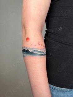 a woman with a small tattoo on her arm