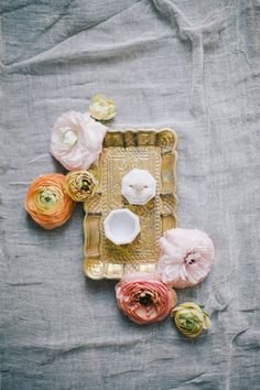 an arrangement of flowers on top of a tray