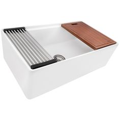 a white sink with a wooden drainer in the middle and a brown strainer at the bottom