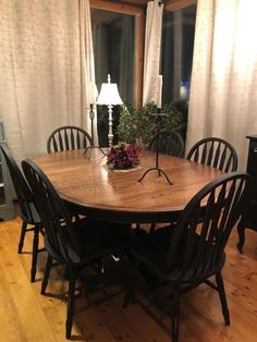 a wooden table with chairs around it