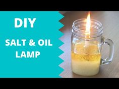 a candle that is in a glass jar with oil on it and the words diy salt & oil lamp