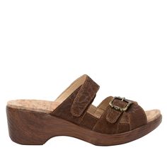 Adjustability is taken beyond the limits in this '40's-inspired leather sandal on a slip-resistant lightweight wood look wedge outsole. For some added femininity, there's an adjustable crisscross strap detailed with an ornate buckle. Step inside and the comfort continues with a cushioned footbed lined with soft microsuede. Featured in a Delicut Tawny colorway on an embossed genuine leather upper. Take this sandal with you from day to night! Classic Brown Wedge Heel Sandals, Brown Slip-on Wedge Sandals With Buckle Closure, Classic Wedge Heel Sandals With Leather Sole, Classic Brown Sandals With Wooden Heel, Step Inside, Hook And Loop, Work Boots, Smooth Leather, Leather Sandals