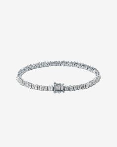 This Classic Diamond Mini Baguette Tennis Bracelet is one of our bestselling styles. We love this piece for its elegance and wear-ability. Beautiful mini baguette diamonds are meticulously set in a vertically staggered setting for a modern feel. Stack it next to one of our bangles for an elevated look. Details 18k rose gold, white gold or yellow gold 2.90 carats of baguette diamonds Bracelet measures 7" inches in length 4mm width Ref: AKB348 Modern Diamond Bracelet With Baguette Cut Accents, Modern Baguette Cut Diamond Bracelet With Accents, Modern Diamond Tennis Bracelet With Baguette Cut, Modern Baguette Cut Diamond Bracelet, Modern Tennis Bracelet With Baguette Diamonds And Cubic Zirconia, Timeless White Gold Diamond Bracelet With Baguette Diamonds, Classic Tennis Bracelet With Baguette Diamonds For Formal Occasions, Classic Formal Tennis Bracelet With Baguette Diamonds, Modern Diamond Baguette Bracelet