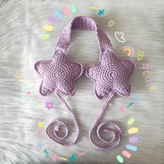 a crocheted purse and matching hat are laying on a bed with confetti