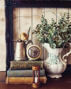 a vase filled with flowers sitting on top of a table next to an old book