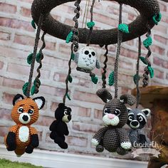 crocheted stuffed animals hanging from a tree