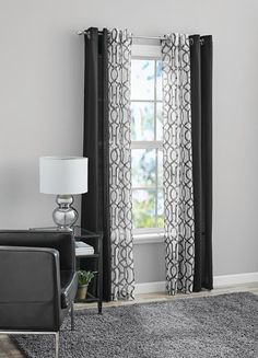 a black and white living room with curtains