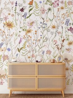 a floral wallpaper with wicker furniture in front of it and flowers on the wall