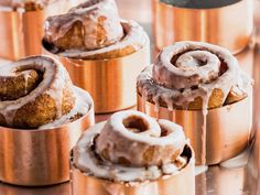 several cinnamon rolls sitting on top of a metal pan