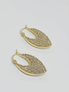 "This is a pair of 14K yellow gold and 14K white gold dangle/drop earrings. The majority of the earrings are yellow gold, but the sides have white gold incorporated in the almost leaf-like details. Material(s): 14K yellow gold + 14K white gold Total Weight: 3.6 grams Flaws (if any): None to mention Marking(s): \"14K\" Measurements: The drop length of these earrings is 25 millimeters. The width, laying flat, is 17 millimeters. The thickness of these earrings is 4.1 millimeters. If you have any qu Gold Drop Hoop Earrings Fine Jewelry, Yellow Gold Oval Filigree Earrings, Oval Yellow Gold Filigree Earrings, Yellow Gold Drop Hoop Earrings For Anniversary, Luxury Gold Pear-shaped Earrings, Anniversary Yellow Gold Drop Hoop Earrings, Silver 14k Gold Teardrop Hoop Earrings, Silver Teardrop Hoop Earrings In 14k Gold, Yellow Gold Oval Pierced Earrings