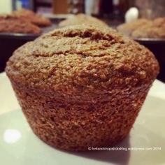 a muffin sitting on top of a white plate next to other muffins