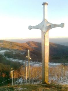 a large white cross on top of a hill