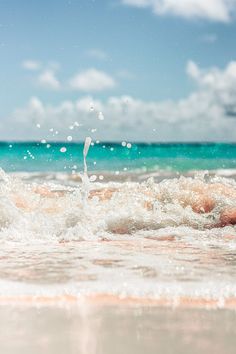 the water is splashing onto the beach