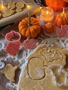 some cookies are laying on a table with pumpkins and other holiday decorations in the background