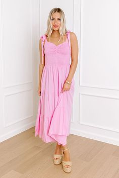 - Stroll through summer in this beautiful midi! With its adorable smocked bodice and sweet tied straps, it's an adorable piece of sunny style. Perfect for picnics, parties, or just feeling fabulous any day of the week! - Lightweight material - A built-in skirt lining - A sweetheart neckline with ruched detail - A smocked bodice - 1-inch tied straps - Functional side pockets - Flowy yet flattering silhouette that ends in a midi length hemline Cute Pink Smocked Dress With Smocked Back, Pink Sundress With Adjustable Straps For Day Out, Pink Vacation Dress With Knotted Straps, Casual Pink Dress With Knotted Straps, Pink Sundress With Ruffled Straps For Summer, Beach Midi Smocked Dress With Adjustable Straps, Spring Smocked Midi Dress With Tie Straps, Pink Beach Dress With Knotted Straps, Pink Summer Sundress With Tie Straps