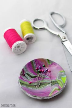 two spools of thread sitting on top of a plate next to each other