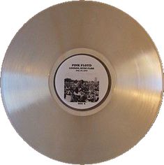 the pink floyd album is shown on a white disc with black lettering and an image of people