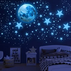 a bedroom with stars and the moon in the night sky wall decals on the walls